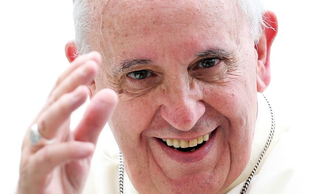 Pope Francis waves as he leads his weekly audience in Saint Peter's Square at the Vatican