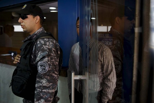 A police officer stands guard at the main entrance of the clinic where arrested Caracas metropolitan mayor Antonio Ledezma was transferred due to medical problems in Caracas