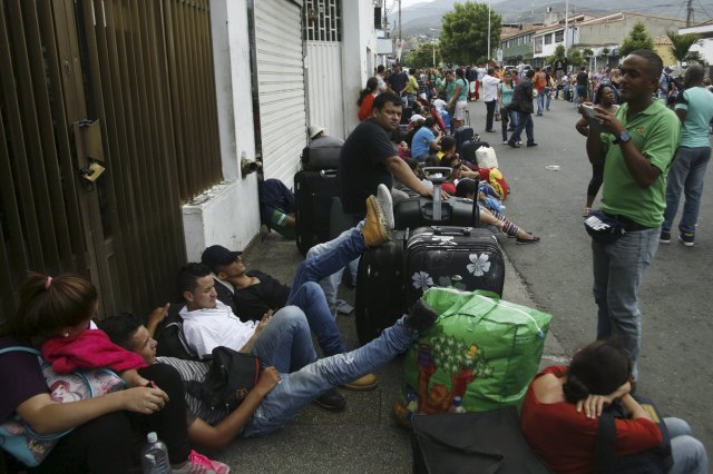 People queue while they wait to cross the border to Colombia at San Antonio in Tachira state, Venezuela, August 23, 2015. Venezuela's closure of two border crossings with Colombia hurts innocent people, Colombia's President Juan Manuel Santos said on Saturday, adding that he hoped to speak to his Venezuelan counterpart Nicolas Maduro to find a solution. Maduro closed the crossings on Wednesday after a shootout between smugglers and troops left three soldiers wounded. He declared a 60-day state of emergency in five border municipalities on Friday, and deployed a contingent of 1,500 soldiers in the border area to join the 500 already stationed there. REUTERS/Carlos Eduardo Ramirez