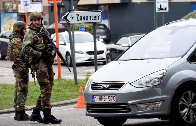 Belgian troops man a checkpoint outside Brussels airport in Zaventem on March 24, 2016, two days after terror attacks in the Belgian capital. Police in Brussels ramped up a desperate hunt for a fourth man suspected of taking part in the Islamic State bombings that struck at the very heart of Europe. Flags in the shellshocked city of Brussels hung at half-mast as Belgium mourned the 31 people from all over the world killed in the attacks, while doctors battled to save scores more injured in the carnage. / AFP / PATRIK STOLLARZ