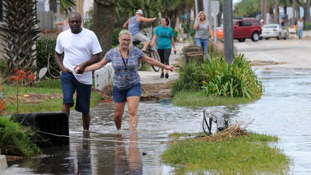 MAT01. JACKSONVILLE (EE.UU.), 08/10/2016.- Personas transitan por calles inundadas hoy, sábado 8 de octubre de 2016, luego del paso del Huracán Matthew en Jacksonville, Florida (Estados Unidos). Florida amaneció hoy abocada a las labores de recogida de árboles caídos y a la restauración del tendido eléctrico tras el devastador paso del huracán Matthew, que de acuerdo a los primeros reportes ocasionó cuatro muertes en este estado. EFE/GERARDO MORA