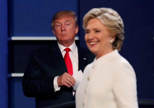 Republican U.S. presidential nominee Donald Trump and Democratic U.S. presidential nominee Hillary Clinton finish their third and final 2016 presidential campaign debate at UNLV in Las Vegas, Nevada, U.S., October 19, 2016.      REUTERS/Mike Blake       TPX IMAGES OF THE DAY