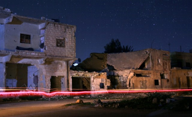 En la imagen se aprecian edificios dañados de noche en la localidad de Dael, en manos de rebeldes, en la gobernación de Daraa, Siria, el 21 de enero de 2017. Fotografía tomada usando exposición larga. El Ejército sirio y sus aliados expulsaron a Estado Islámico de varias aldeas al este de Alepo el domingo, informaron una unidad periodística militar manejada por Hezbollah y un grupo observador del conflicto, llevándolos más cerca del territorio en poder de los rebeldes respaldados por Turquía. REUTERS/Alaa Al-Faqir