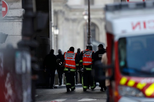 French firefighters and police are seen at the site near the Louvre Pyramid in Paris, France, February 3, 2017 after a French soldier shot and wounded a man armed with a knife after he tried to enter the Louvre museum in central Paris carrying a suitcase, police sources said. REUTERS/Christian Hartmann