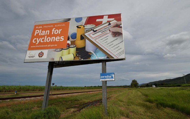 A cyclone warning sign is seen outside the city of Townsville in far north Queensland on March 27, 2017. Thousands of people including tourists were evacuated on March 27, 2017 as northeast Australia braced for a powerful cyclone packing destructive winds with warnings of major structural damage and surging tides. / AFP PHOTO / PETER PARKS