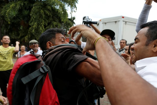 Supporters of Venezuela's President Nicolas Maduro and opposition supporters, clash during a protest outside the Supreme Court of Justice (TSJ) in Caracas