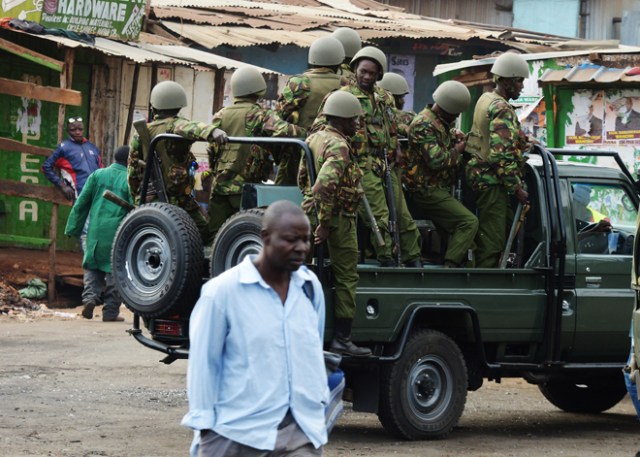 Kenyan riot police officers patrol on August 12, 2017 in the Kawangware neighborhood of Nairobi.  Eight bodies have been taken to the Nairobi city morgue from three slums which erupted into protests after President Uhuru Kenyatta was declared the victor in a disputed election, a senior police officer said August 12. Seven had sustained gunshot wounds, he said noting the eight bodies came from the Mathare, Kibera and Kawangware areas. "They have all been taken to the City mortuary," he said, on condition of anonymity.  / AFP PHOTO / STR / SIMON MAINA