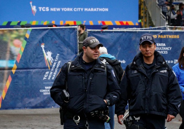 New York City Police (NYPD) officers walk near the finish line of the New York City Marathon in Central Park in New York, U.S. November 5, 2017. REUTERS/Brendan McDermid