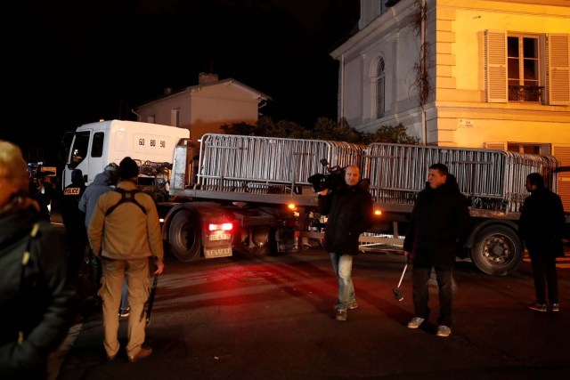 Journalists work in front of late French singer and actor Johnny Hallyday's home in Marnes-la-Coquette near Paris, France December 6, 2017. REUTERS/Benoit Tessier