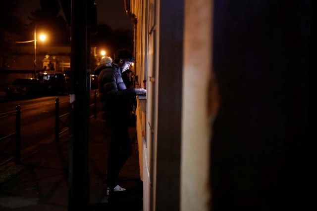 A journalists works in front of late French singer and actor Johnny Hallyday's home in Marnes-la-Coquette near Paris, France December 6, 2017. REUTERS/Benoit Tessier