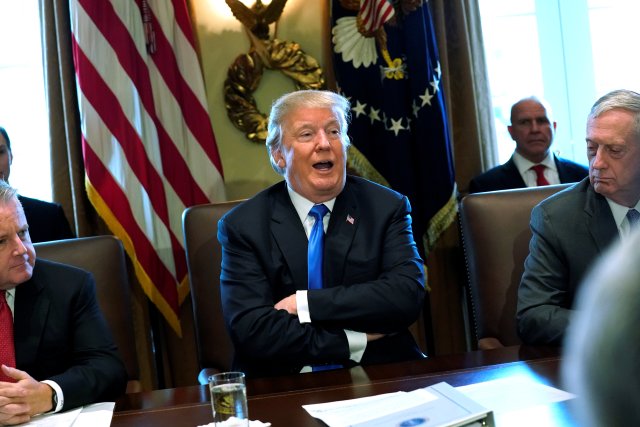 U.S. President Donald Trump, flanked by Deputy Secretary of State John Sullivan (L) and Defense Secretary James Mattis (R), speaks to reporters before he holds a cabinet meeting at the White House in Washington, U.S. December 6, 2017.  REUTERS/Jonathan Ernst