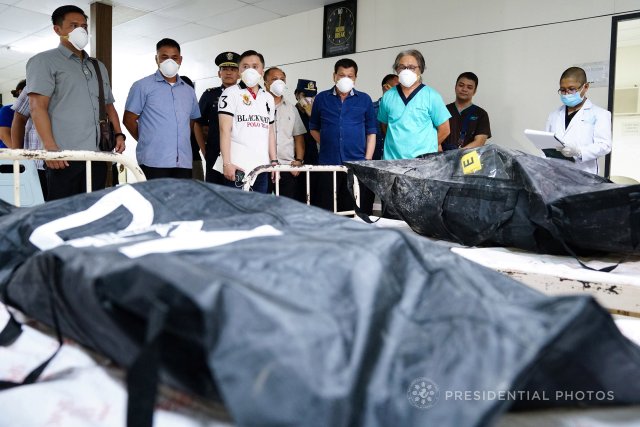 Philippines' President Rodrigo Duterte visits the remains of the victims, who died in the recent fire incident at the New City Commercial Center (NCCC) mall, at the Southern Philippines Medical Center (SPMC) in Davao city, southern Philippines December 25, 2017. Picture taken December 25, 2017. Courtesy of Philippines Presidential Palace/Handout via REUTERS ATTENTION EDITORS - THIS IMAGE WAS PROVIDED BY A THIRD PARTY. NO RESALES. NO ARCHIVES.