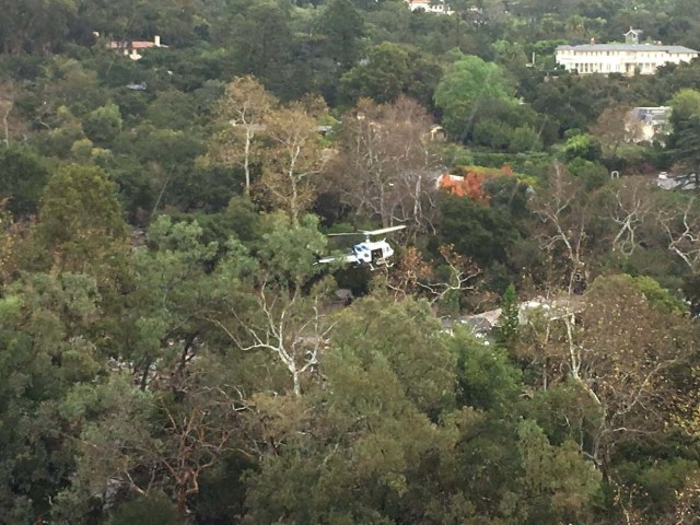 A helicopter hovers above a site damaged by mudslide in Montecito, California, U.S. January 9, 2018. Ventura County Sheriff's Office/via REUTERS THIS IMAGE HAS BEEN SUPPLIED BY A THIRD PARTY. MANDATORY CREDIT.NO RESALES. NO ARCHIVES