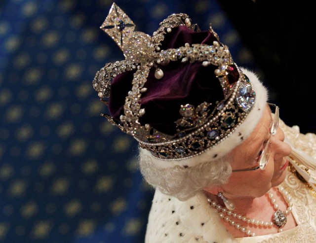 FILE PHOTO: Britain's Queen Elizabeth walks through the Royal Gallery in the Palace of Westminster during the State Opening of Parliament in London, Britain, May 25, 2010. REUTERS/Luke MacGregor/File Photo