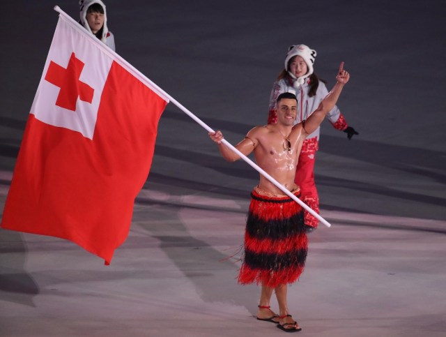 Pyeongchang 2018 Winter Olympics – Opening ceremony – Pyeongchang Olympic Stadium - Pyeongchang, South Korea – February 9, 2018 - Pita Taufatofua of Tonga carries the national flag. REUTERS/Carlos Barria