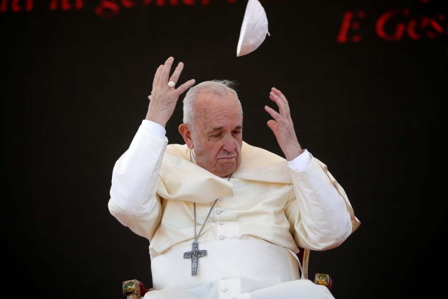 A gust of wind blows Pope Francis's skull cap off during his pastoral visit in Alessano, southern Italy, April 20, 2018. REUTERS/Max Rossi