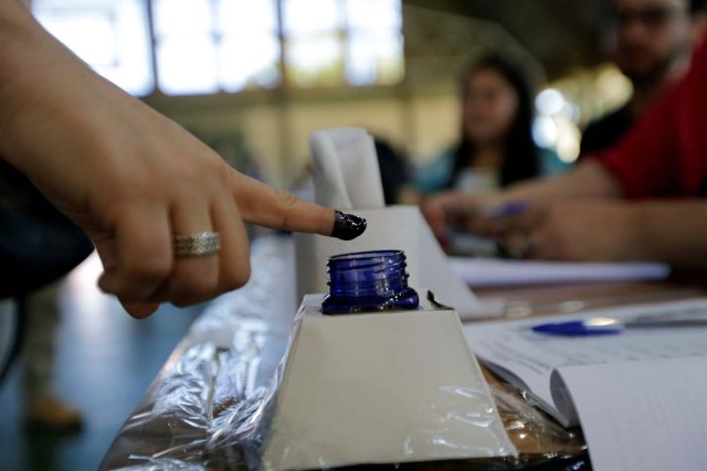 A woman inks his finger before casting her vote during elections in Asuncion, Paraguay, April 22, 2018. REUTERS/Mario Valdez