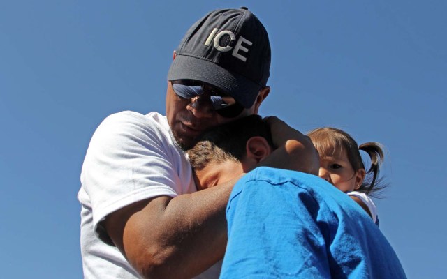 Ivan Castaneda (40), a former Mexican soldier deported two weeks ago from the United States, embraces his children at the bank of the Rio Grande during the event called "Abrazos No Muros" (Hugs, not walls) promoted by the Border Network of Human Rights organization in the border line between El Paso, Texas, United States and Ciudad Juarez, Chihuahua state, Mexico on May 12, 2018. Castaneda was denied a political asylum he requested in 2012 to flee violence in Ciudad Juarez, while his wife, mother and five children remain in Denver, Colorado, United States. / AFP PHOTO / HERIKA MARTINEZ
