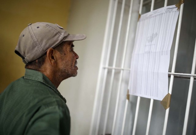 A Venezuelan voter checks an electoral list at a polling station during the presidential election in Caracas, Venezuela, May 20, 2018. REUTERS/Carlos Garcia Rawlins