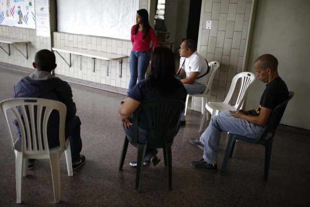 Electoral officials await voters at a polling station during the presidential election in Caracas, Venezuela, May 20, 2018. REUTERS/Carlos Garcia Rawlins